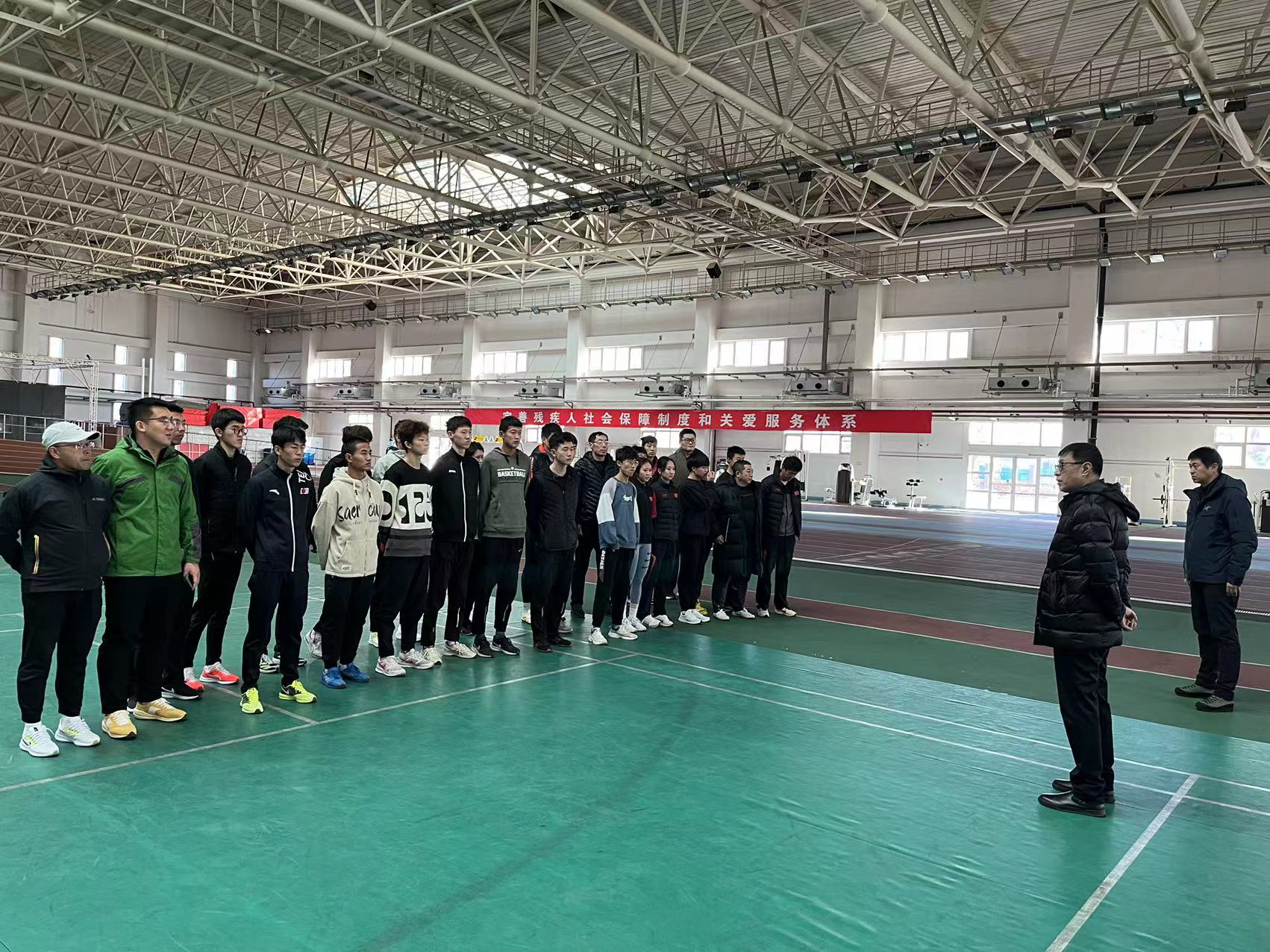 图为调研组在田径训练场地强调安全生产工作
